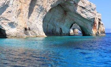 Adventurers discovering natural wonders and caves in Greece.