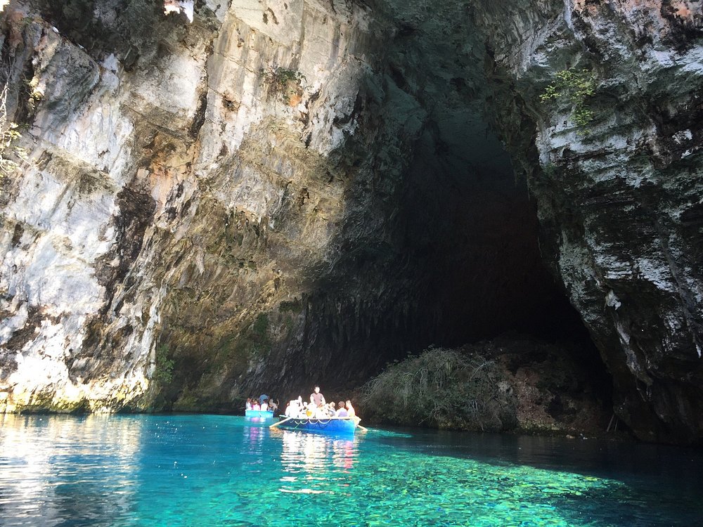 Adventurers discovering natural wonders and caves in Greece.