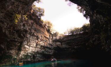 Adventurers discovering natural wonders and caves in Greece.
