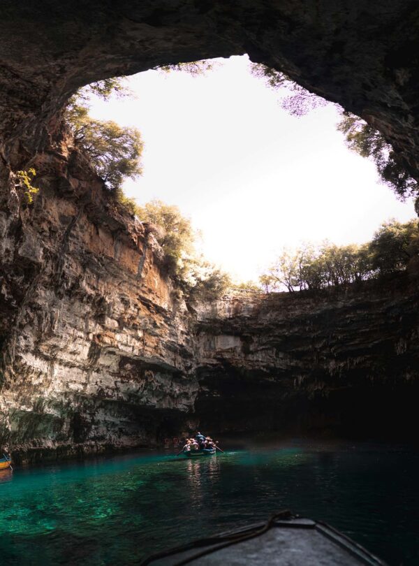 Adventurers discovering natural wonders and caves in Greece.