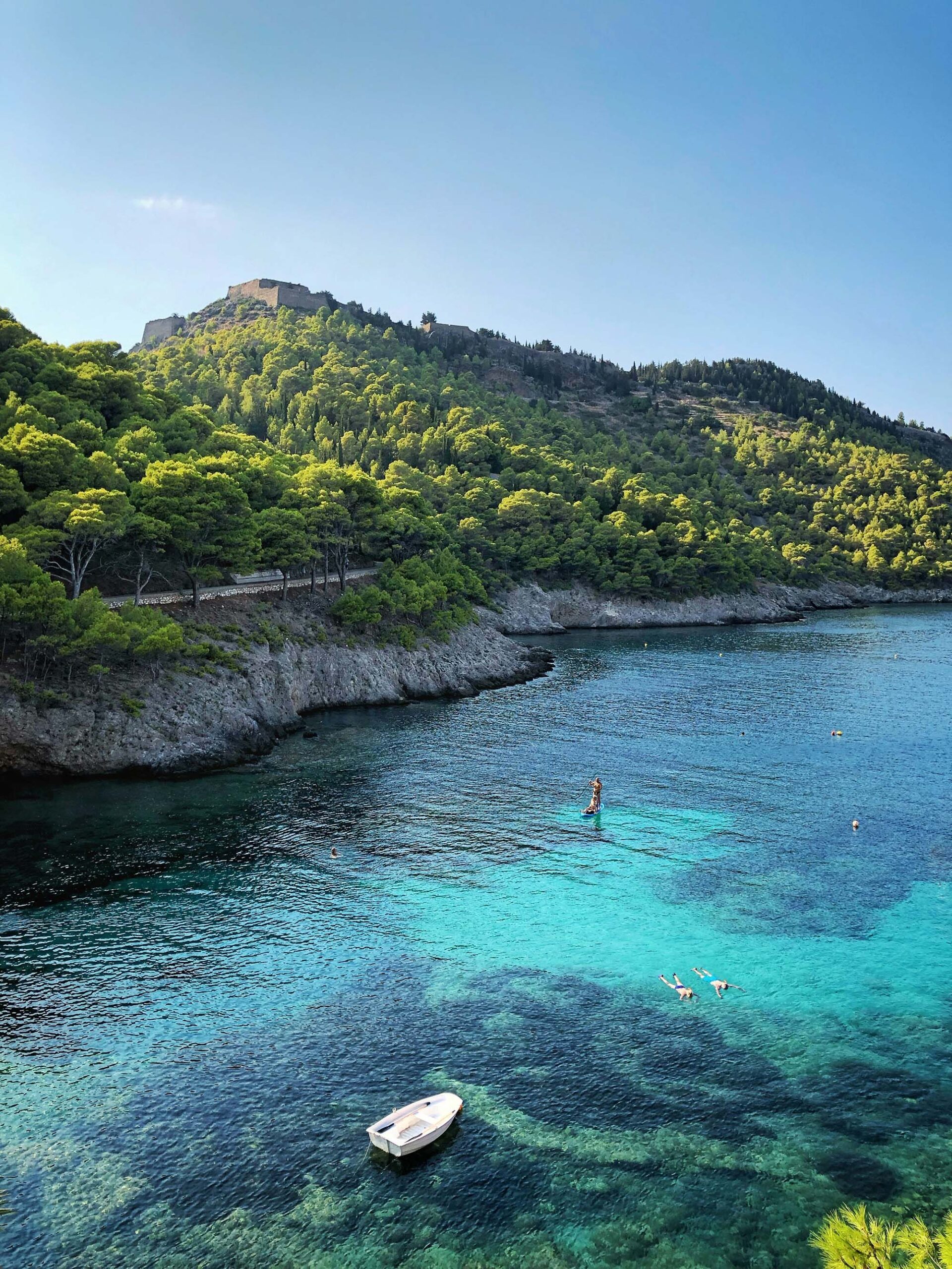 Adventurers discovering natural wonders and caves in Greece.
