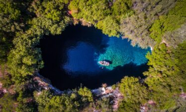 Adventurers discovering natural wonders and caves in Greece.